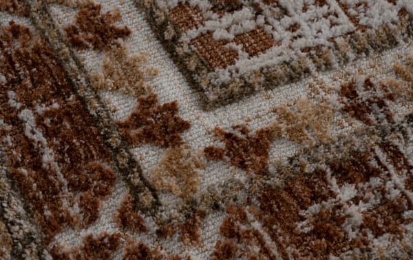 Transitional Hazel 5' x 7' Russet Abstract Rug with plush polyester fabric, featuring an orange and russet abstract pattern and soft texture.