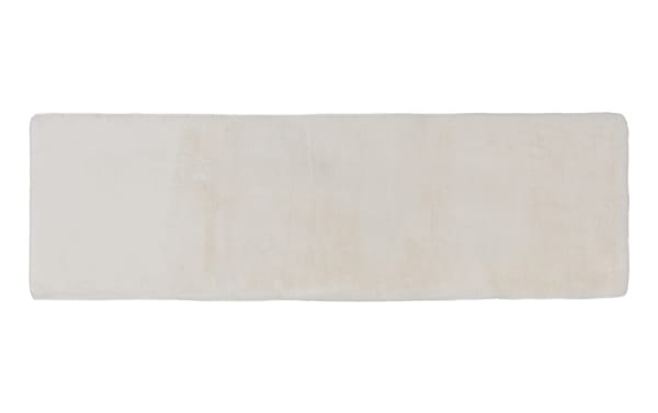Long rectangular beige faux fur rug with a soft, plush texture, suitable for cozy home decor or bedroom use.