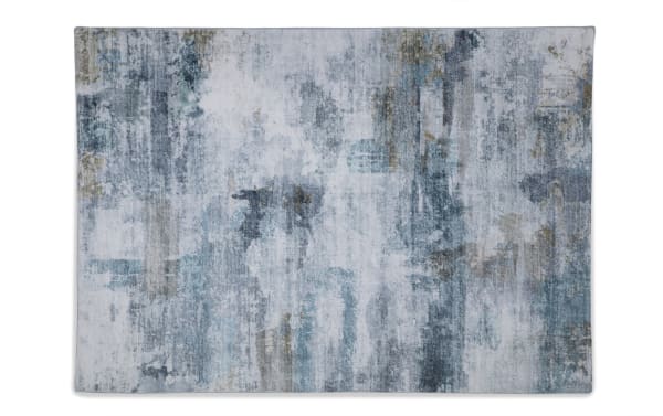 Abstract area rug with a distressed pattern in shades of blue, gray, and beige, featuring a soft, textured surface suitable for modern home decor.