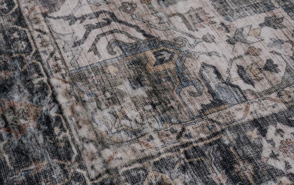 Multicolored Basil 5' x 7' transitional oriental rug with intricate patterns in charcoal, beige, and blue polyester fabric, featuring memory foam cushioning.