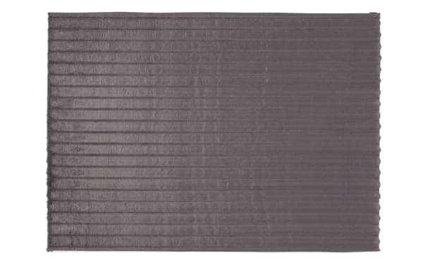 Sofia Channel 5' x 7' charcoal solid rug with plush polyester fabric and cushioned memory foam padding, featuring a soft, ribbed transitional design.