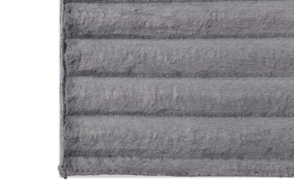 Charcoal gray Sofia Channel 5' x 7' transitional rug with soft polyester fabric and cushioned memory foam for plush comfort.