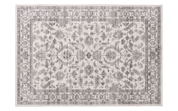 Vintage-style area rug with intricate floral and vine patterns in muted gray tones on a light beige background, featuring a detailed border design.