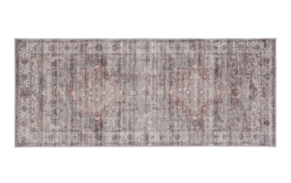 Vintage-style rectangular area rug runner with muted gray, beige, and rust tones, featuring a distressed floral medallion pattern and intricate border design.