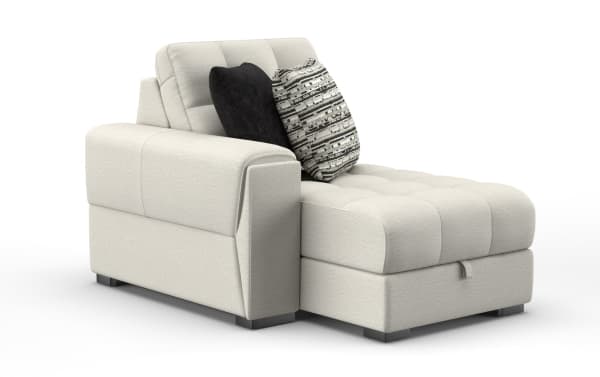 Modern beige fabric chaise lounge with tufted cushions, featuring two decorative pillows in black and patterned gray, ideal for living room seating.
