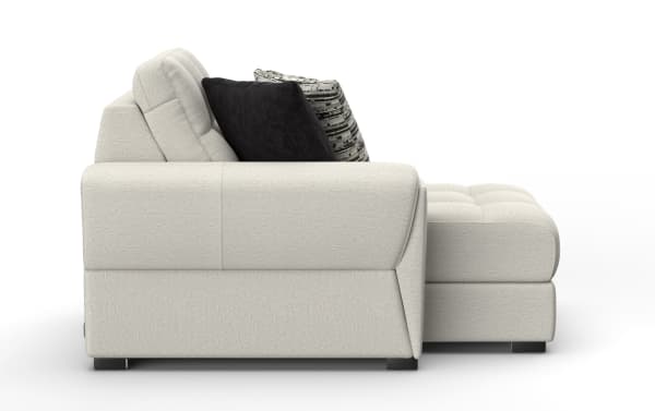 Modern light gray fabric sectional sofa with tufted cushions, black and patterned accent pillows, and a chaise lounge on the right side.