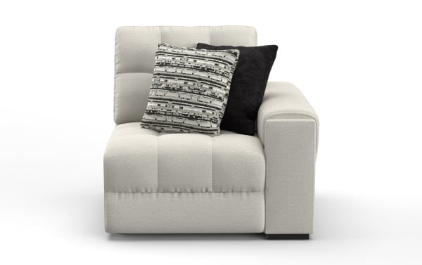 Modern light gray fabric sectional sofa corner with tufted cushions and two decorative throw pillows, one black and one patterned.