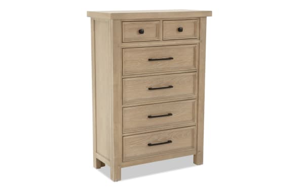 Light wood chest of drawers with five drawers, black metal handles, rustic finish, suitable for bedroom storage furniture.