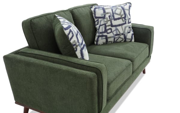 Tribeca Green 66'' Loveseat in mid-century modern style with green polyester fabric upholstery, memory foam cushions, and patterned accent pillows.