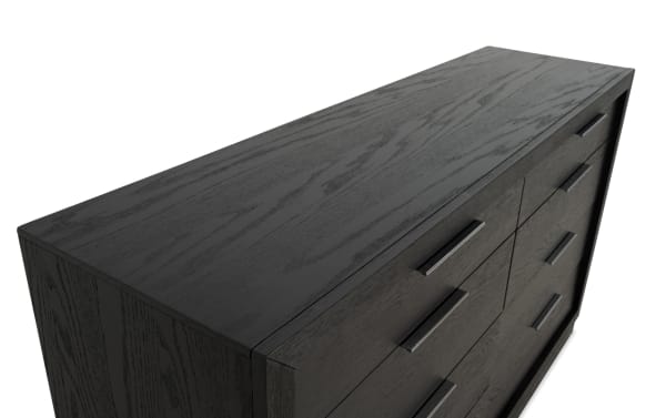 Dark wood dresser with a smooth finish, featuring six drawers with sleek black metal handles, showcasing modern bedroom storage furniture.