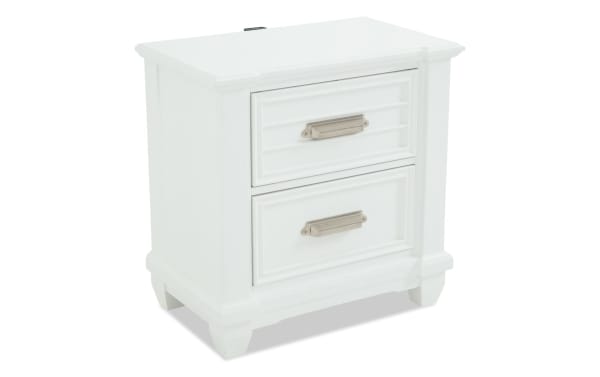 Sunset Cove White 2 Drawer Nightstand in coastal style, made of white MDF with slatted drawer fronts, brushed metal handles, and built-in USB/USB-C ports.