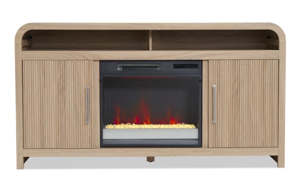 Wooden electric fireplace TV stand with light oak finish, two vertical slatted cabinet doors with metal handles, open shelf, and realistic flame effect heater.