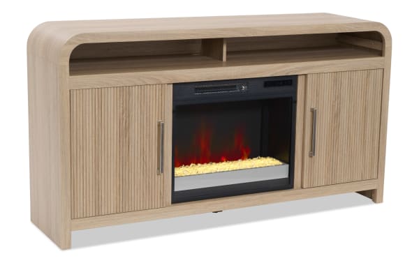 Light wood TV stand with built-in electric fireplace, featuring two storage cabinets with vertical grooves and metal handles, and open shelves.