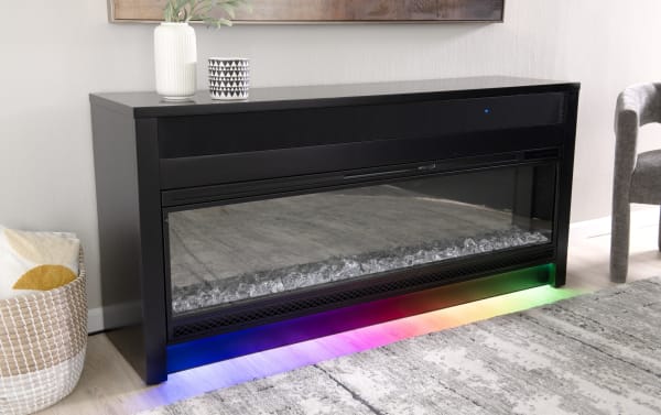 Contemporary Prism 64" black MDF and tempered glass electric fireplace TV stand with Bluetooth soundbar, mood lighting, adjustable thermostat, and auto-shutoff.