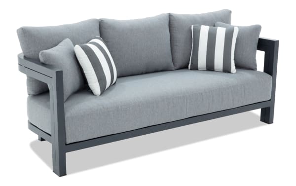 Modern gray fabric sofa with dark metal frame, featuring plush back cushions and striped accent pillows, ideal for contemporary living rooms.