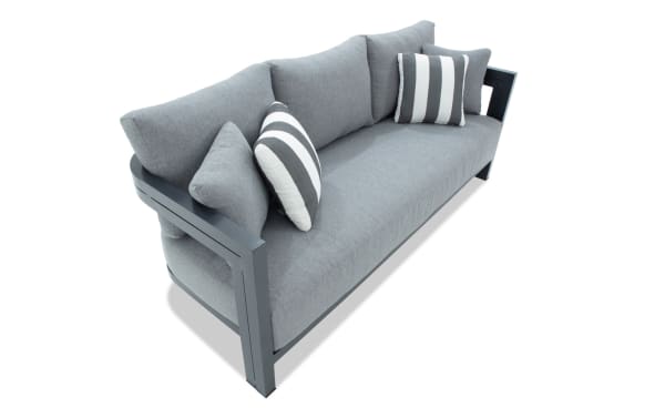 Modern gray fabric sofa with metal frame, featuring plush cushions and two striped accent pillows, ideal for contemporary living rooms.