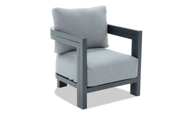 Modern outdoor armchair with dark gray metal frame and light gray cushioned seat and backrest, designed for patio or garden seating.