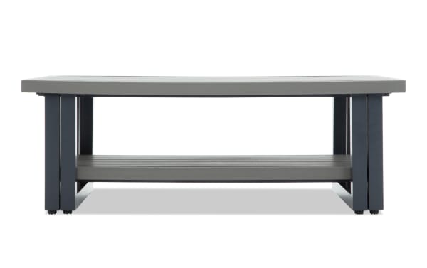 Modern rectangular outdoor coffee table with a gray composite wood top and shelf, supported by black metal legs for durability and style.