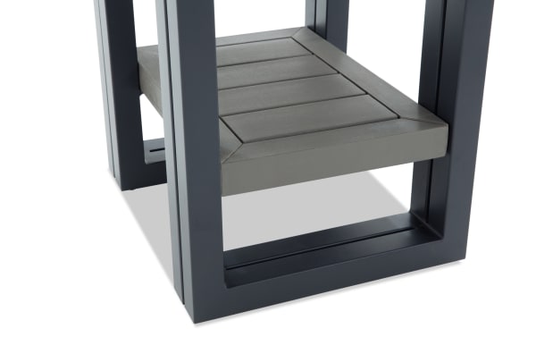 Modern outdoor side table leg with a dark gray metal frame and a gray wooden slatted lower shelf, showcasing sturdy construction and contemporary design.