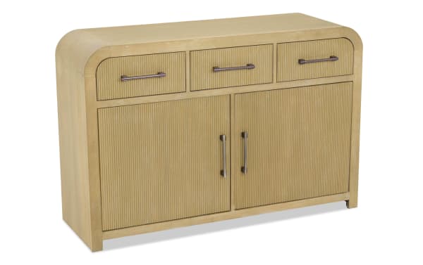 Light wood sideboard with ribbed texture, three top drawers, two cabinet doors, and bronze metal handles, modern design.