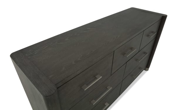 Dark wood dresser with a smooth finish, featuring multiple drawers with modern metal handles, ideal for bedroom storage.