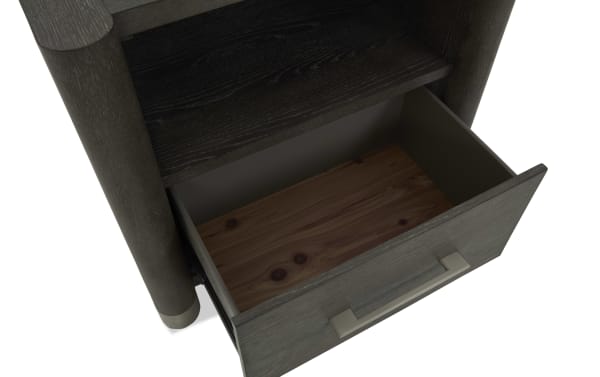 Dark wood nightstand drawer open, showing smooth interior with natural wood grain bottom, metal handle, and rounded legs.
