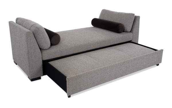 Transitional brown Daydreamer daybed with polyester fabric upholstery, featuring a pop-up sleeper with memory foam and density foam for comfort.