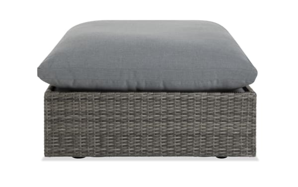Dream Gray Wicker Outdoor Ottoman with oversized reversible gray polyester cushion, all-weather wicker, and rust-free aluminum frame from Dream Outdoor collection.