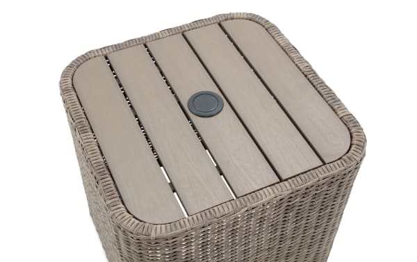 Outdoor square side table with light brown synthetic wicker frame and wood-look slatted top, featuring a central umbrella hole.