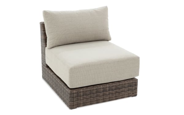 Modular Bob® Beige & Brown Wicker Outdoor Armless Chair with beige polyester cushions, all-weather wicker base, and rust-proof aluminum frame in transitional style.