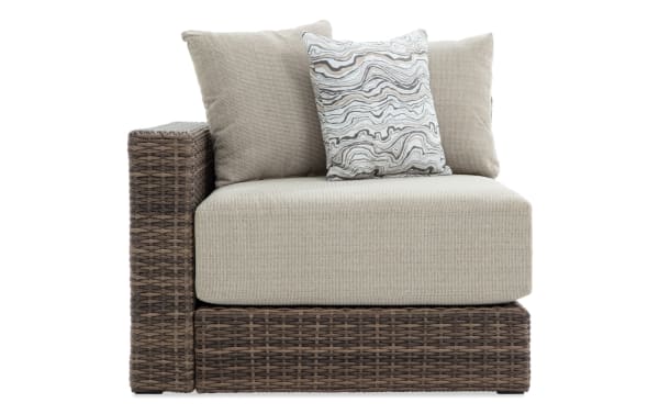Modular Bob® Beige & Brown Wicker Outdoor Left Arm Facing Chair with beige polyester cushions, all-weather wicker, aluminum frame, transitional style.