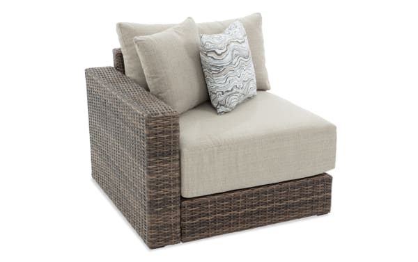 Modular Bob® Beige & Brown Wicker Outdoor Left Arm Facing Chair with beige polyester cushions, all-weather wicker, and rust-proof aluminum frame in transitional style.
