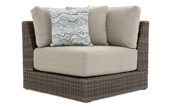 Beige Modular Bob® Outdoor Corner Chair with brown all-weather wicker frame, rust-proof aluminum, and plush polyester cushions from the Modular Bob collection.
