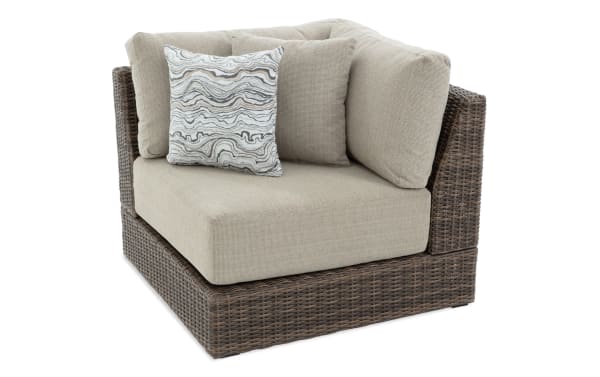Beige Modular Bob® outdoor corner chair with brown all-weather wicker frame, rust-proof aluminum, and plush polyester cushions from the Modular Bob collection.