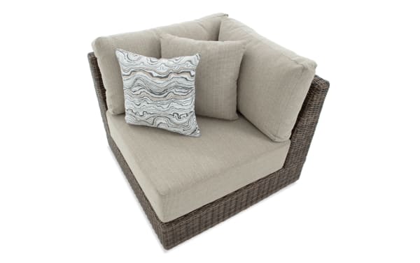 Transitional Modular Bob® Beige & Brown Wicker Outdoor Corner Chair with all-weather wicker, rust-proof aluminum frame, and beige polyester cushions.