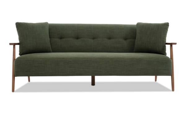 Bettie Avocado Futon in mid-century modern style with avocado green polyester fabric, tufted back, wooden arms, and two matching accent pillows.