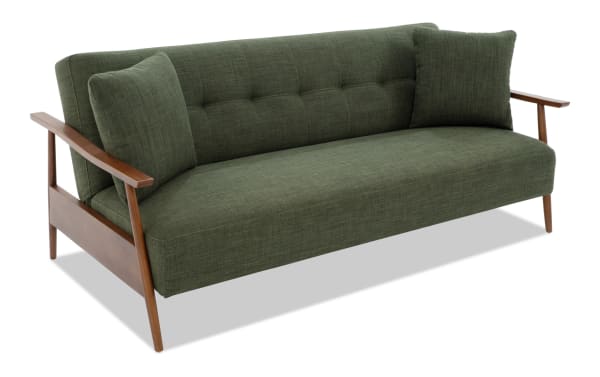 Bettie Avocado Futon in mid-century modern style with tufted polyester fabric upholstery, wooden arms, and two matching accent pillows.