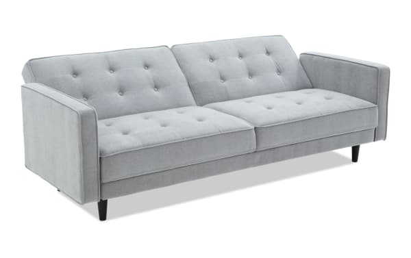 Mellow Gray Futon in soft gray polyester fabric with tufted cushions, transitional style, padded armrests, and black tapered legs, ideal for home office or guest room seating and sleeping.