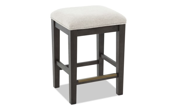 Contemporary Encore Brown & Beige backless counter stool with beige polyester fabric upholstery, acacia veneer frame, and memory foam seat.