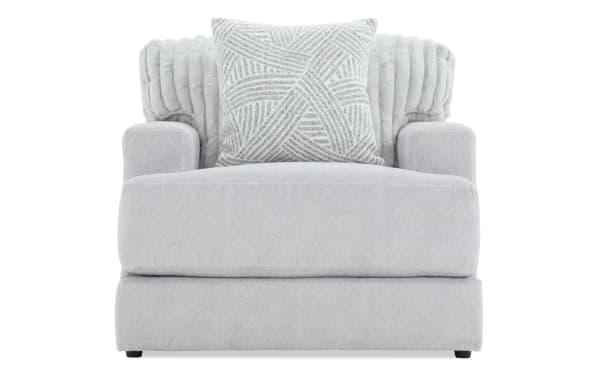 Contemporary Sofia Gray Chair with plush gray polyester fabric, channel tufted back cushions, and matching accent pillow for luxury comfort.