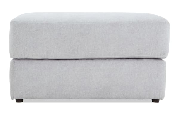 Contemporary Sofia Gray Ottoman in soft gray polyester fabric with plush memory foam cushioning, perfect for stylish comfort and relaxation.