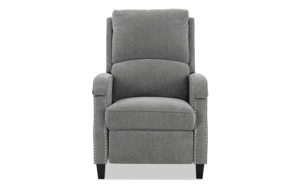 Gray upholstered recliner chair with cushioned back and seat, nailhead trim along arms, and dark wooden legs, suitable for living room seating.