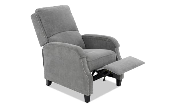 Gray fabric upholstered recliner chair with padded armrests, tufted backrest, nailhead trim accents, and extended footrest for comfort.