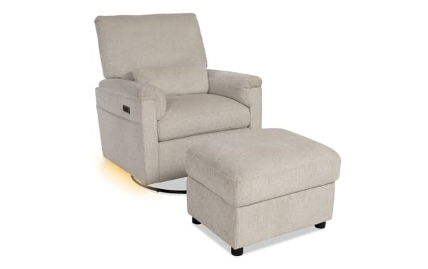 Light beige fabric swivel recliner chair with matching ottoman, padded armrests, lumbar pillow, and built-in side control switch.