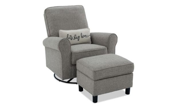 Light gray Cottage Chic fabric polyester swivel glider chair with nailhead accents, matching storage ottoman, and "let's stay home" pillow.