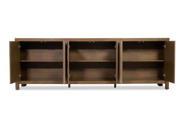 Wooden sideboard cabinet with three compartments, each with double doors and a middle shelf, in a warm brown finish.