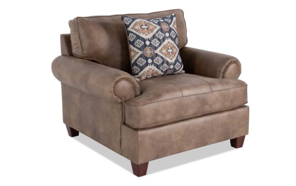 Traditional Raleigh Cognac Chair in brown polyester fabric with faux leather upholstery, rolled arms, wooden legs, and a patterned accent pillow.