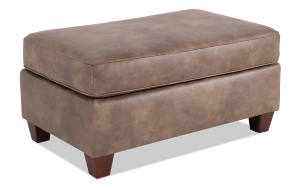 Raleigh Cognac Ottoman in traditional style with brown faux leather polyester upholstery, memory foam cushion, and tapered wood legs.