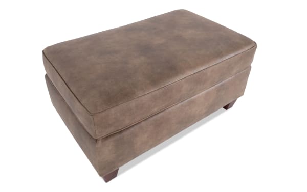 Raleigh Cognac Ottoman in traditional style with brown faux leather polyester upholstery and memory foam cushioning, part of Raleigh collection.