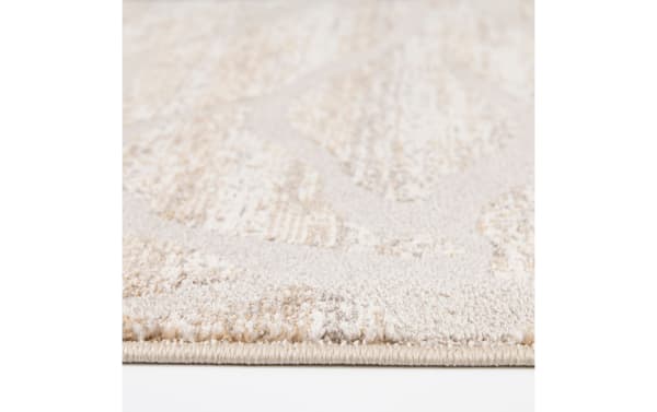 Close-up of the Iris 8' x 10' White Floral Rug showing its soft, medium-height white polypropylene pile with a traditional floral pattern and durable edge binding.
